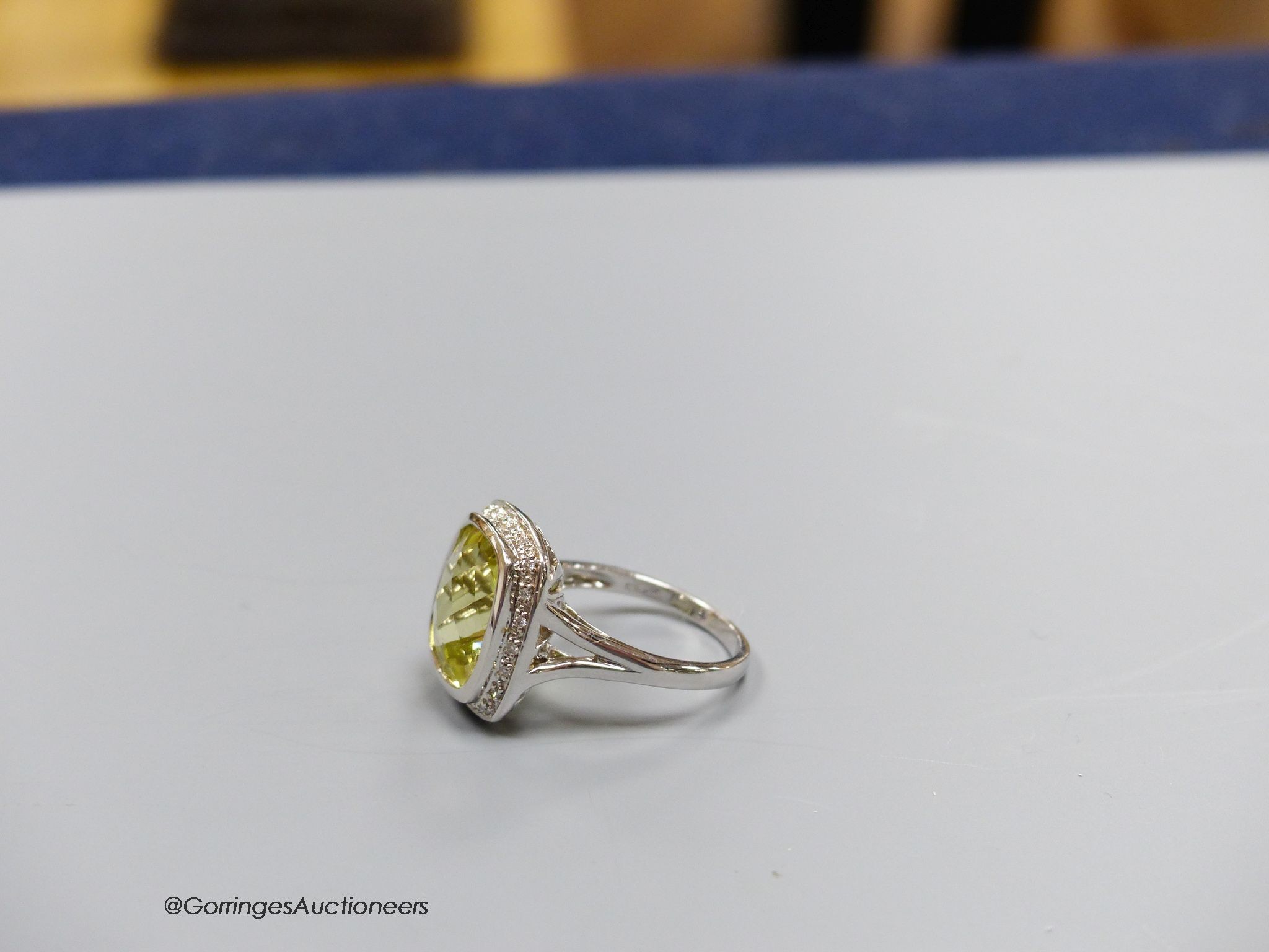 An 18ct white gold, diamond and lemon quartz cluster ring, size N, gross 7.3g.